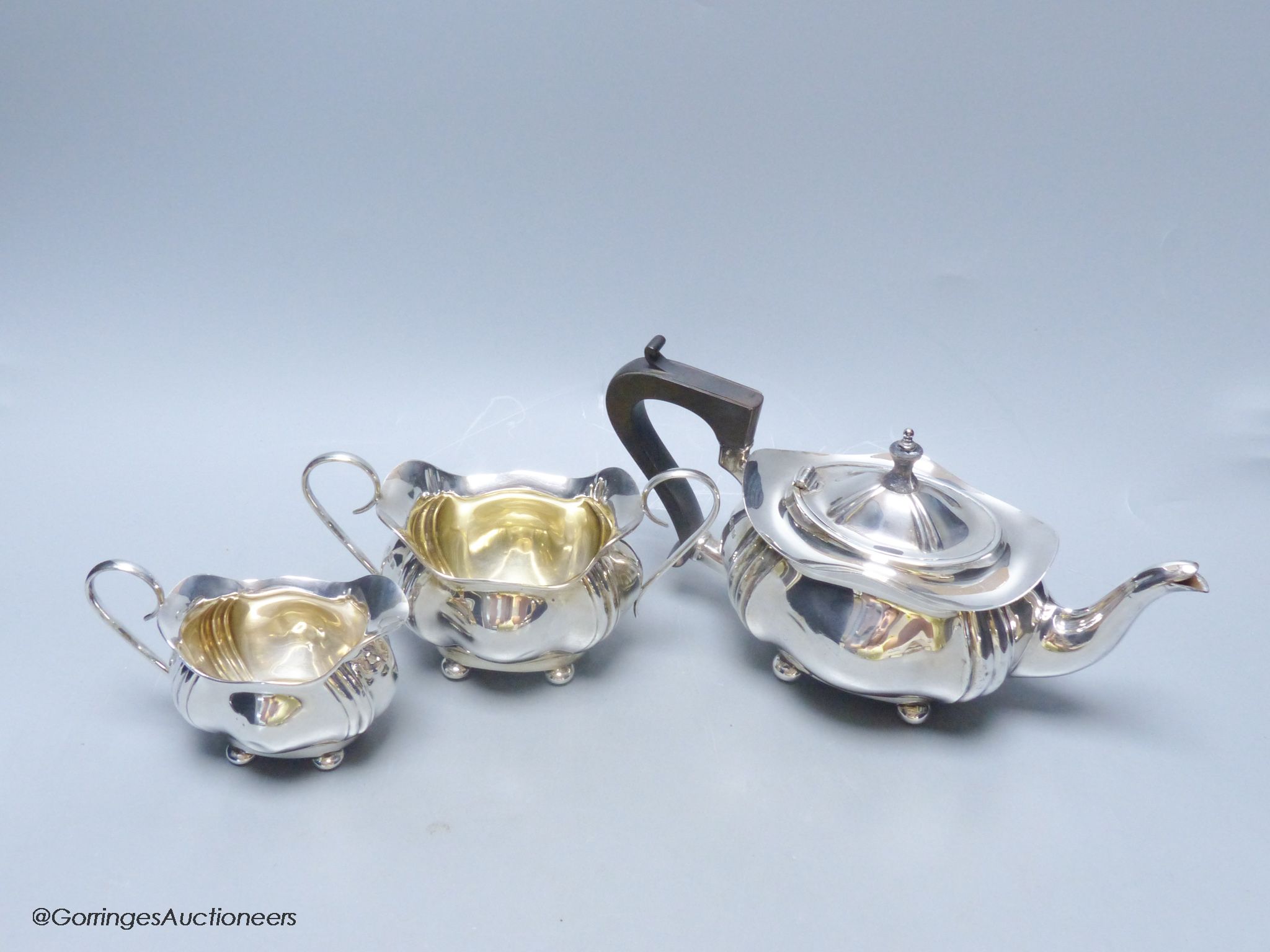 A Scottish silver three-piece tea service, of ribbed, bellied oval form, gross 18.5oz approximately